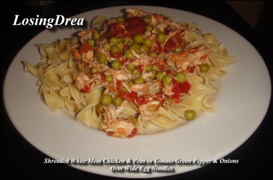 Shreaded Chicken In Tomatoes With Peas Over Wide Egg Noodles