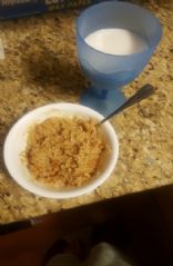 Yummy oatmeal breakfast with a cup of almond milk